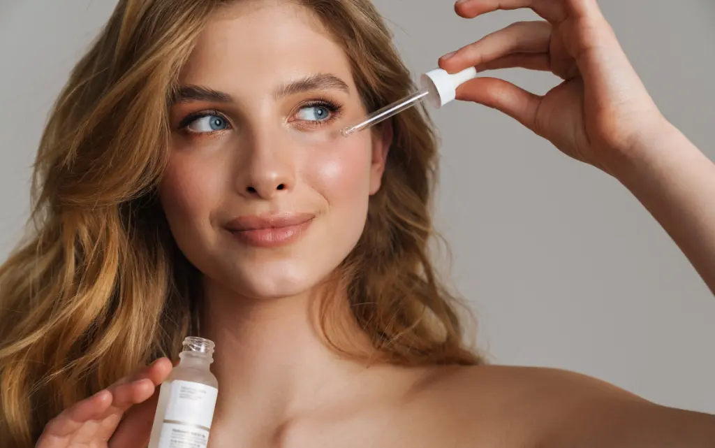 Młoda kobieta trzyma serum nawilżające do cery odwodnionej