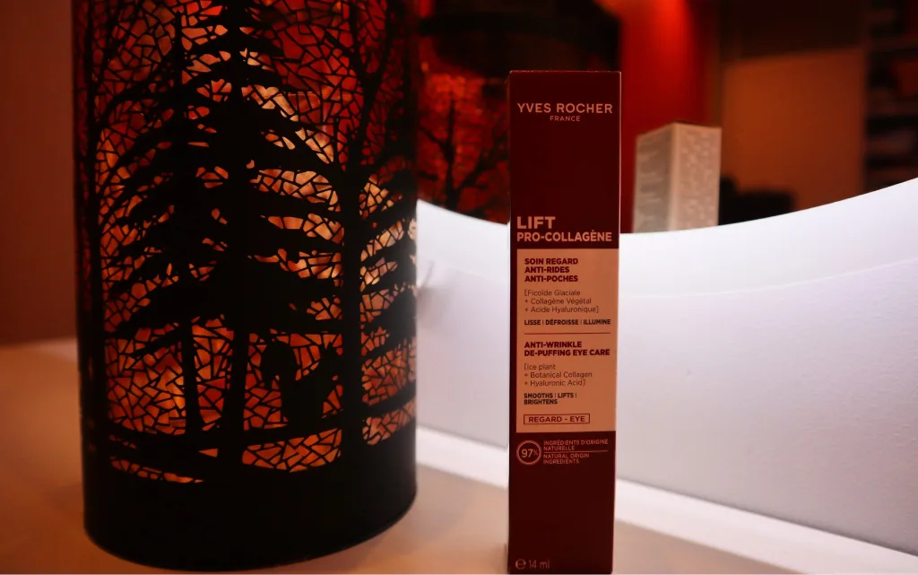 Przeciwzmarszczkowy krem niwelujący worki pod oczami Yves Rocher obok jesiennej lampki