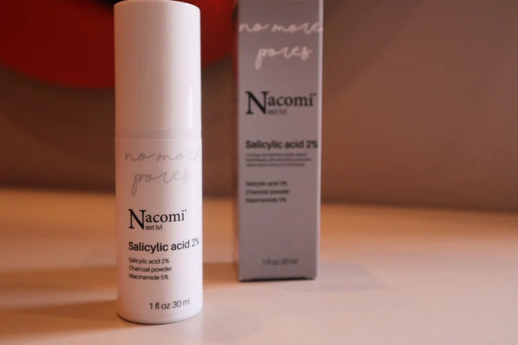 Nacomi Next Level Kwas salicylowy 2% na tle beżowej ściany